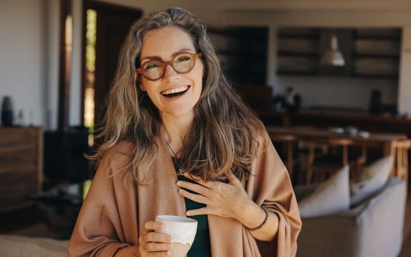 a woman holding a cup