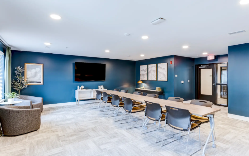 Conference room with long table and blue walls
