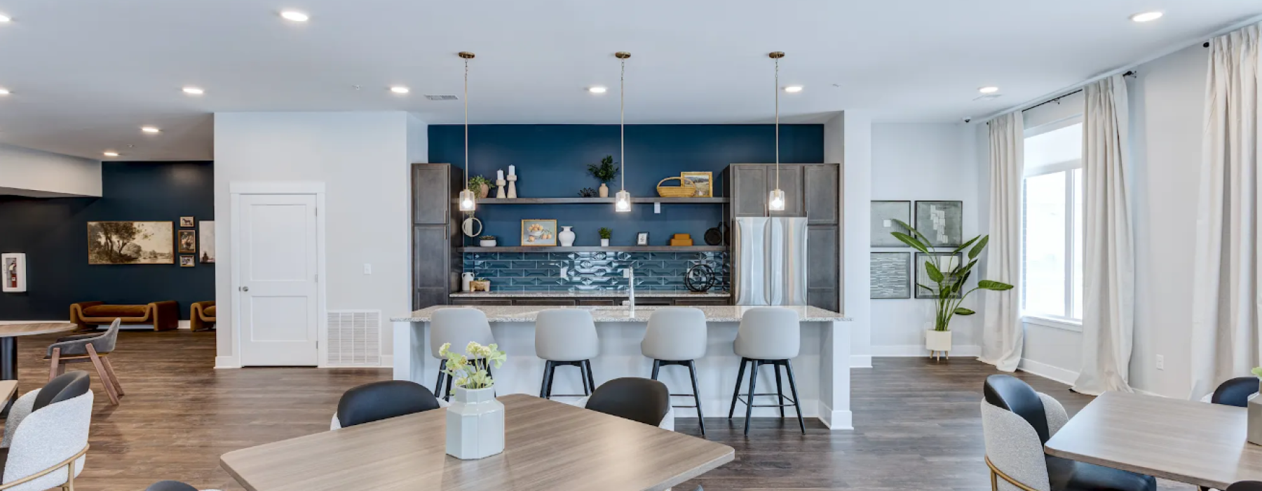 Clubhouse with tables, kitchen, and blue walls