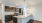 Apartment kitchen with brown cabinets and granite countertops